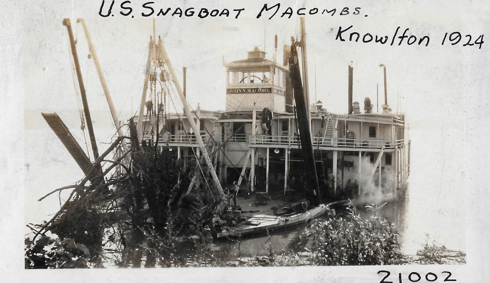 large old ship pulling fallen trees from the river large old ship pulling fallen trees from the river
